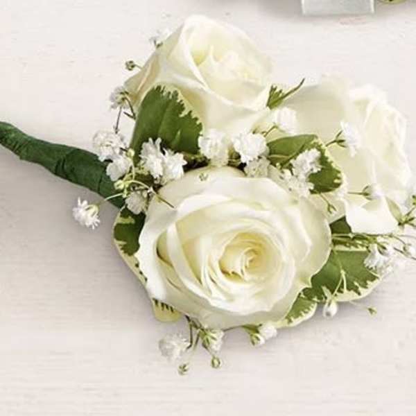 White rose boutonniere with baby's breath and green wrap