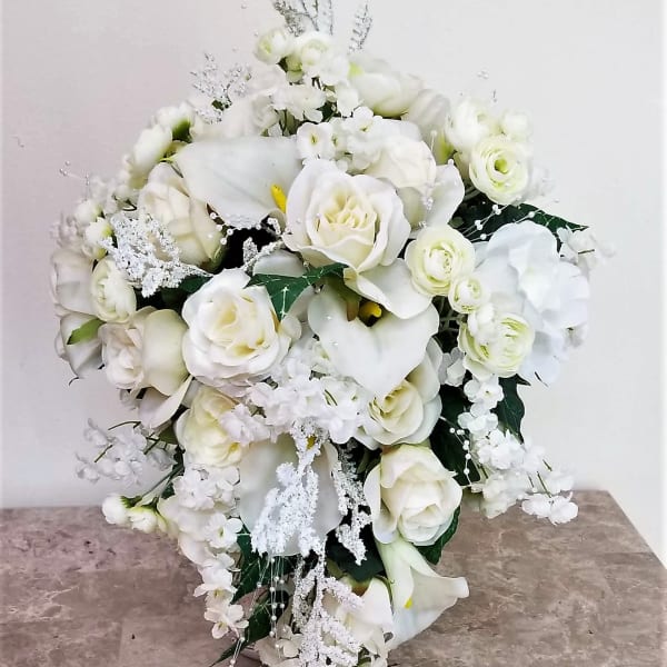 White bridal bouquet with roses, calla lilies, and orchids