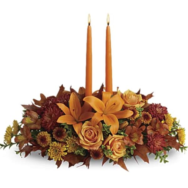 Autumn floral centerpiece with two orange taper candles