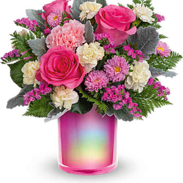 Pink and cream mixed bouquet in a rainbow-tinted glass vase