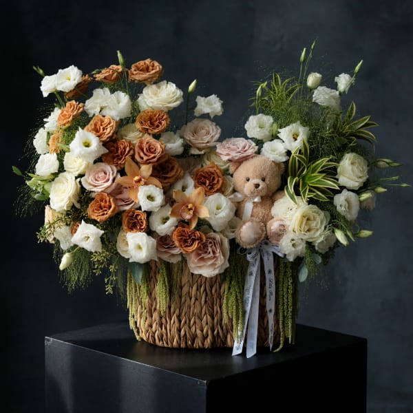 Large flower basket with roses and a teddy bear