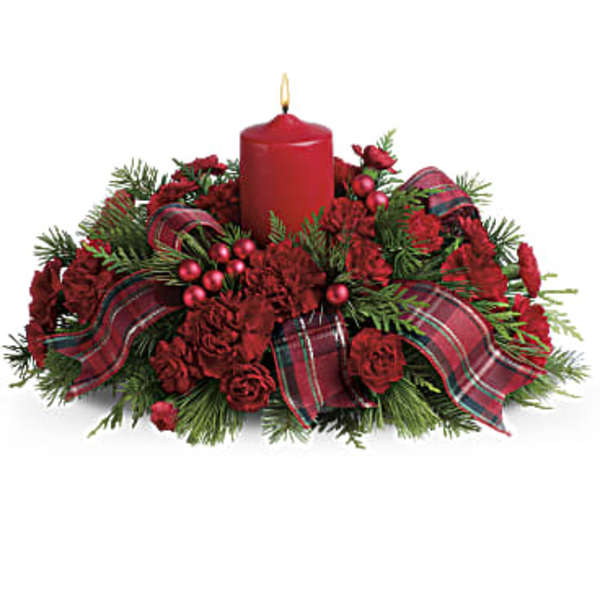 Red candle centerpiece with red flowers and plaid ribbon