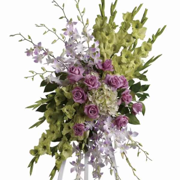 Lavender roses and green orchids on a white easel