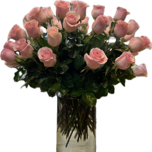 Pink roses arranged in a clear glass vase