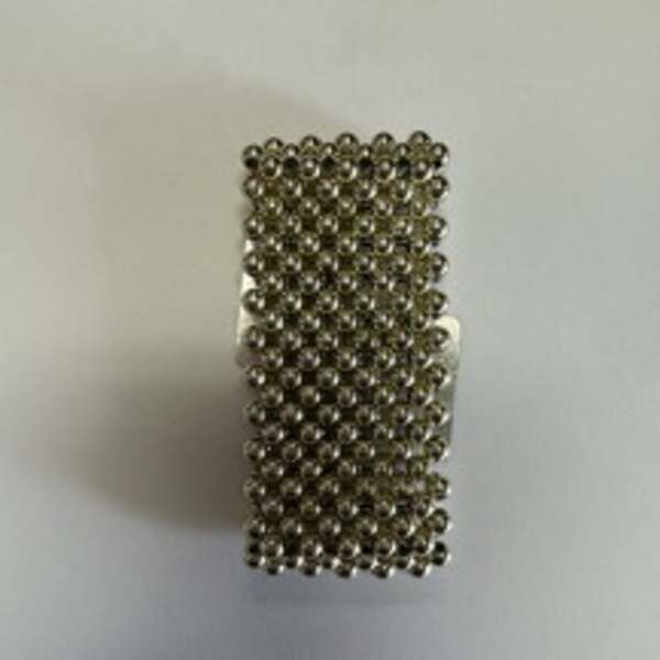 Small rectangular cluster of metallic beads on a light background