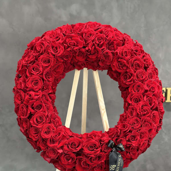 Large red rose wreath on a wooden easel