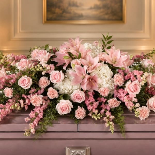 Pink and white floral arrangement with roses, lilies, and carnations