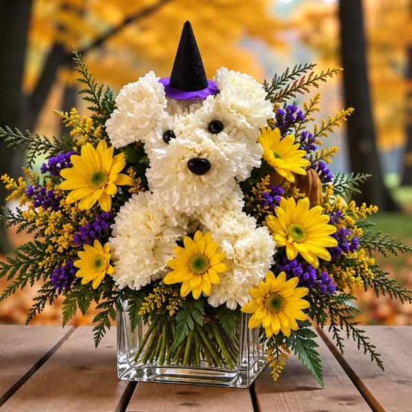 Dog-shaped floral arrangement with a witch hat in a glass vase