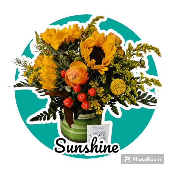 Sunflower bouquet with orange ranunculus in a green striped container