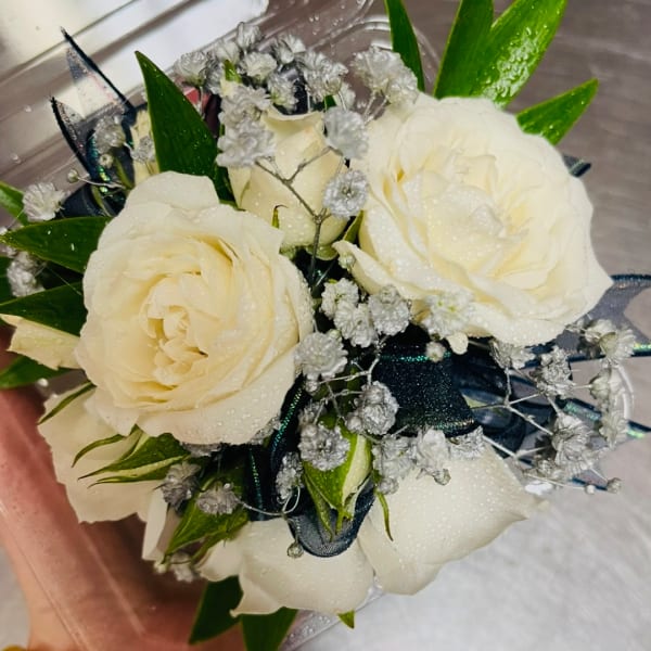 Bouquet of white roses with baby's breath and dark ribbon