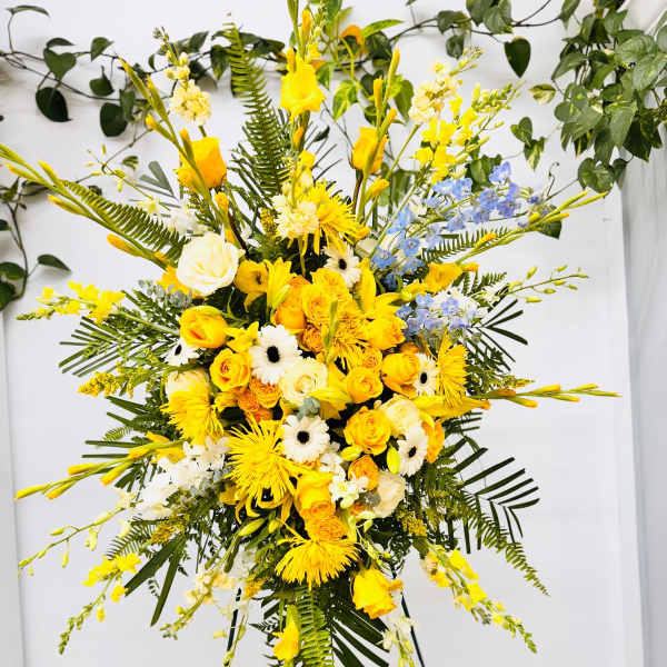 Tall yellow and white floral spray on a stand