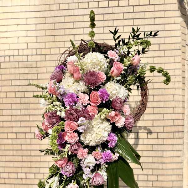 Large cascading floral wreath with pink and white blooms