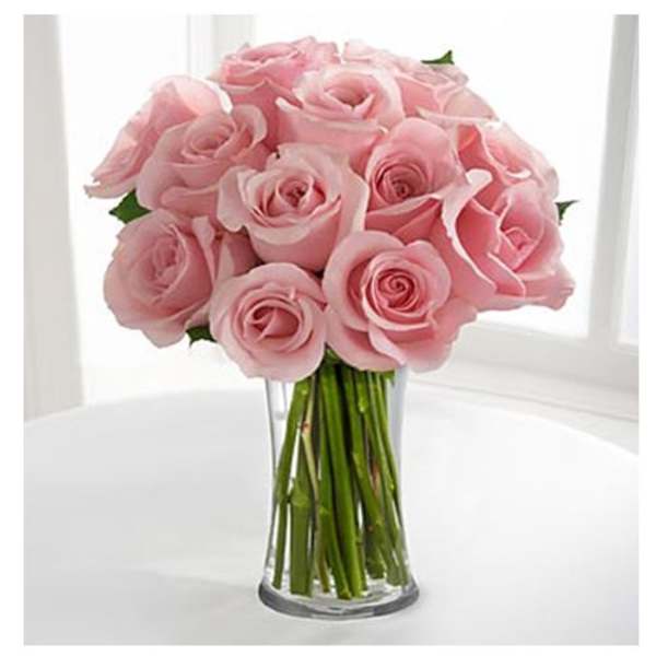 Pink roses arranged in a clear glass vase