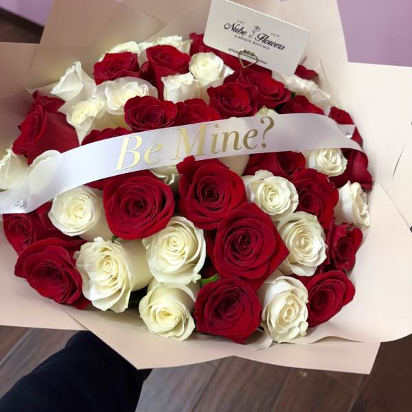 Bouquet of red and white roses with a "Be Mine?" ribbon