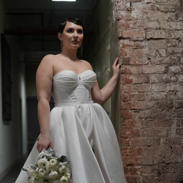 Bride in a white gown holding a white bouquet
