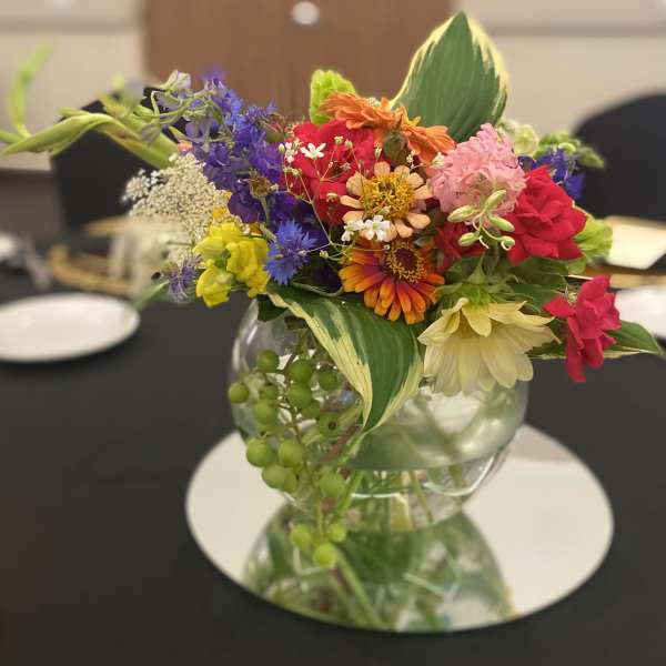 Colorful mixed bouquet in a clear glass vase on a table