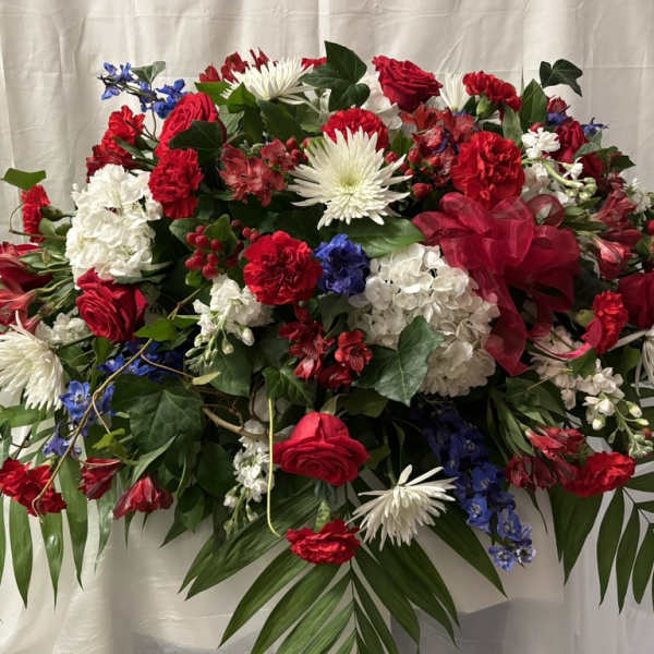 Large red, white, and blue floral spray with palm fronds