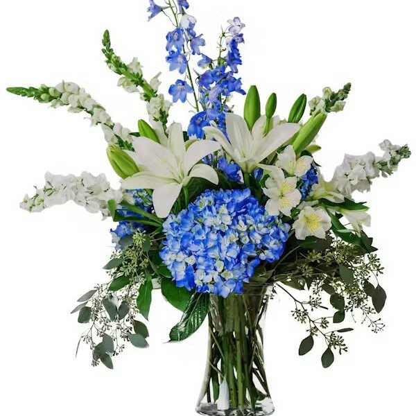 Blue and white floral arrangement in a clear glass vase