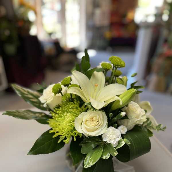 White lily and rose bouquet with green accents