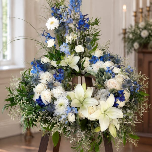 Large white and blue floral wreath on an easel