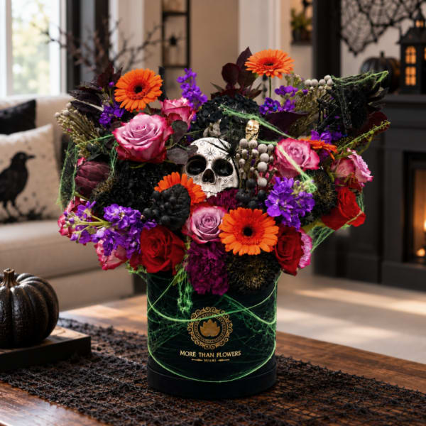 Halloween floral arrangement with a skull centerpiece in a black box
