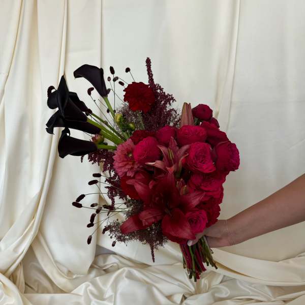 Bouquet of deep red flowers with black calla lilies