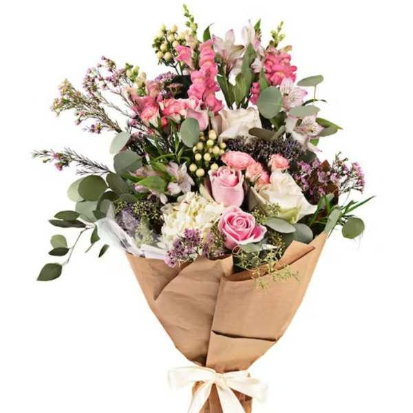 Pink and white mixed bouquet wrapped in brown paper with a ribbon