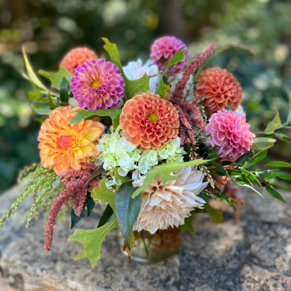 Mixed bouquet of dahlias and hydrangeas in a glass vase