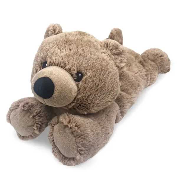 Plush teddy bear lying on a white background
