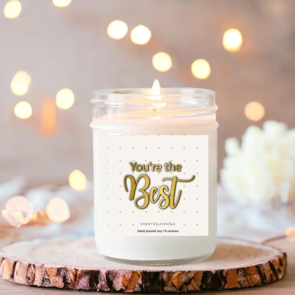 White candle in a glass jar with a "You're the Best" label