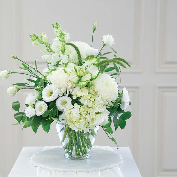 White floral arrangement in a clear glass vase