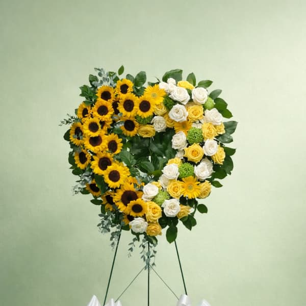 Heart-shaped sunflower and rose standing arrangement on an easel