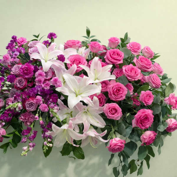 Pink roses and white lilies in a lush floral arrangement