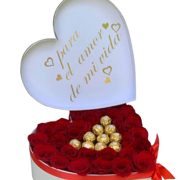 Heart-shaped box of red roses topped with gold-wrapped chocolates