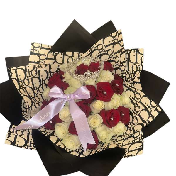Red and white rose bouquet with a ribbon and jeweled crown topper
