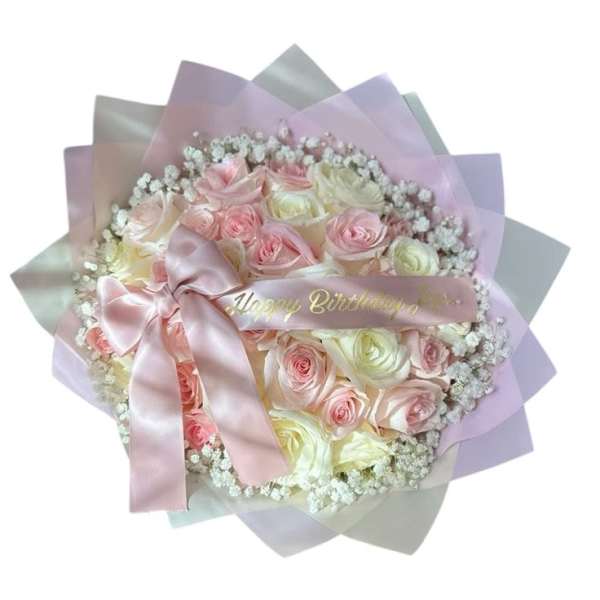 Pink and white rose bouquet wrapped in pastel paper with a satin bow