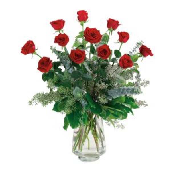 Red roses arranged in a clear glass vase