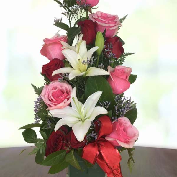 Roses and lilies tower.