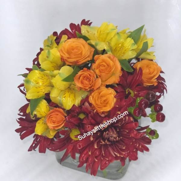 Mix Fall colors with red and orange roses