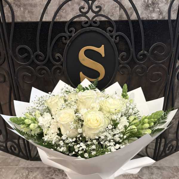 White Flowers Bouquet Wrapped With White Ribbon