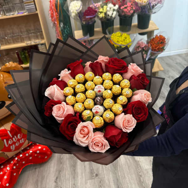 Heart shaped bouquet with red roses and light pink