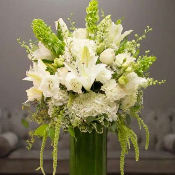 White and Green floral arrangement in a tall vase