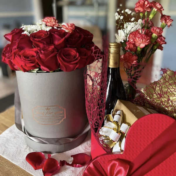 Red roses, red peonies and red wine by lav.ishbouquets