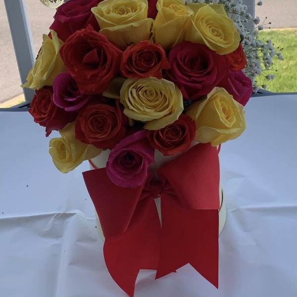 Yellow,red and pink roses along side baby breath arrangement by lav.ishbouquets