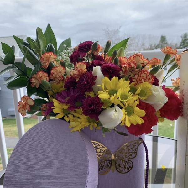 Multi color beautiful flower arrangement in a luxurious lavender box by lav.ishbouquets