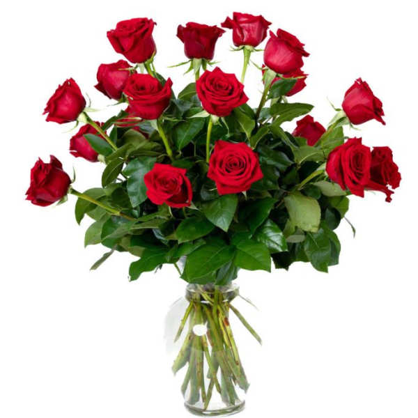 Tall arrangement of long-stemmed red roses in a clear glass vase