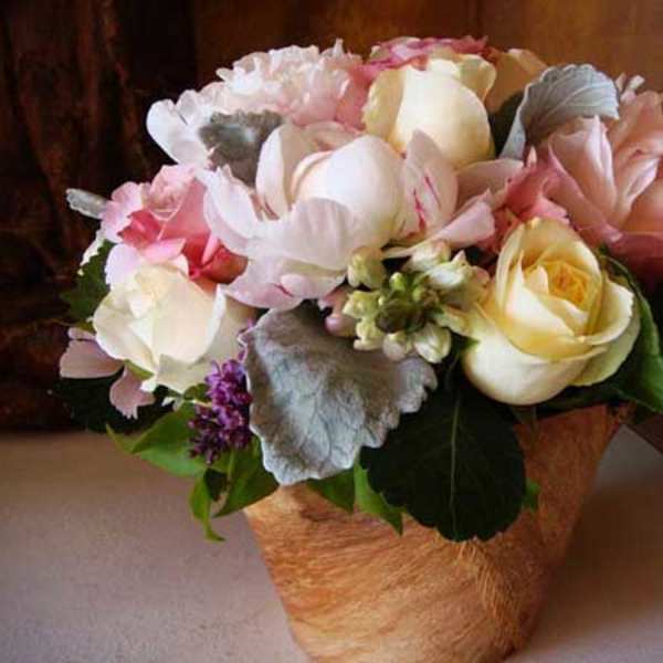 Peony, roses, and snapdragon in a vase wrapped with coconut fiber.