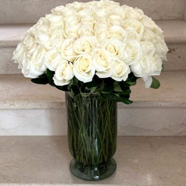 100 Roses White arranged in a vase