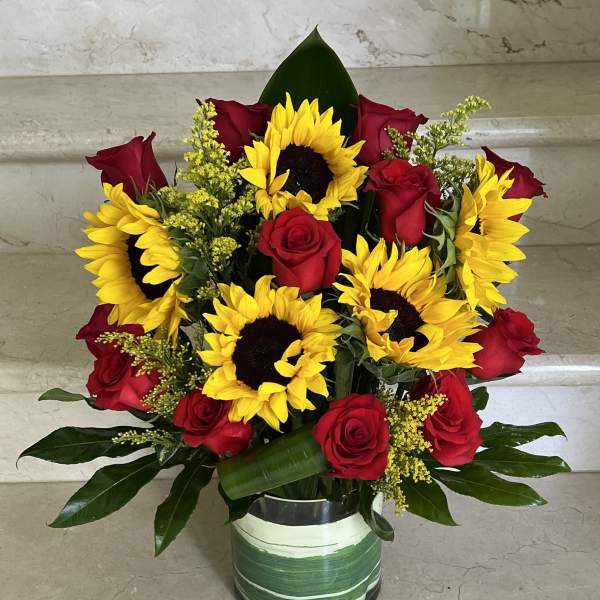 Sunflowers and Red roses arranged in a vase