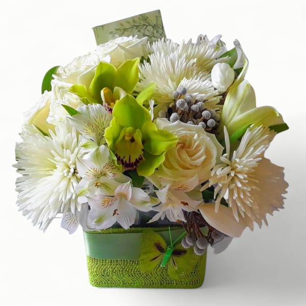 Compact arrangement of white mums, roses, alstroemeria and green orchids in a green square container
